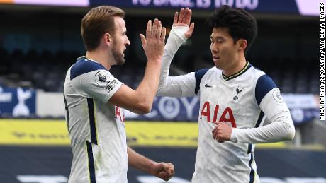 Harry Kane celebrates with Son Heung-min after putting Tottenham Hotspur ahead against Leeds United.  Sun later scored the second goal in a 3--0 victory. 